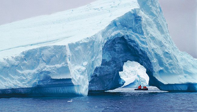 Arched blue iceberg in Antarctic waters