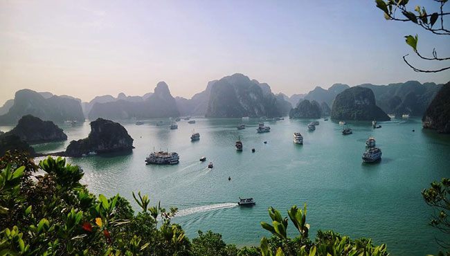 Boats on the green water of Ha Long Bay, Vietnam
